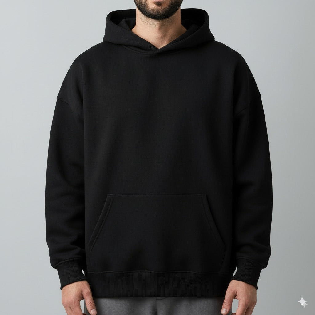 Black hoodie worn by a person on a gray background