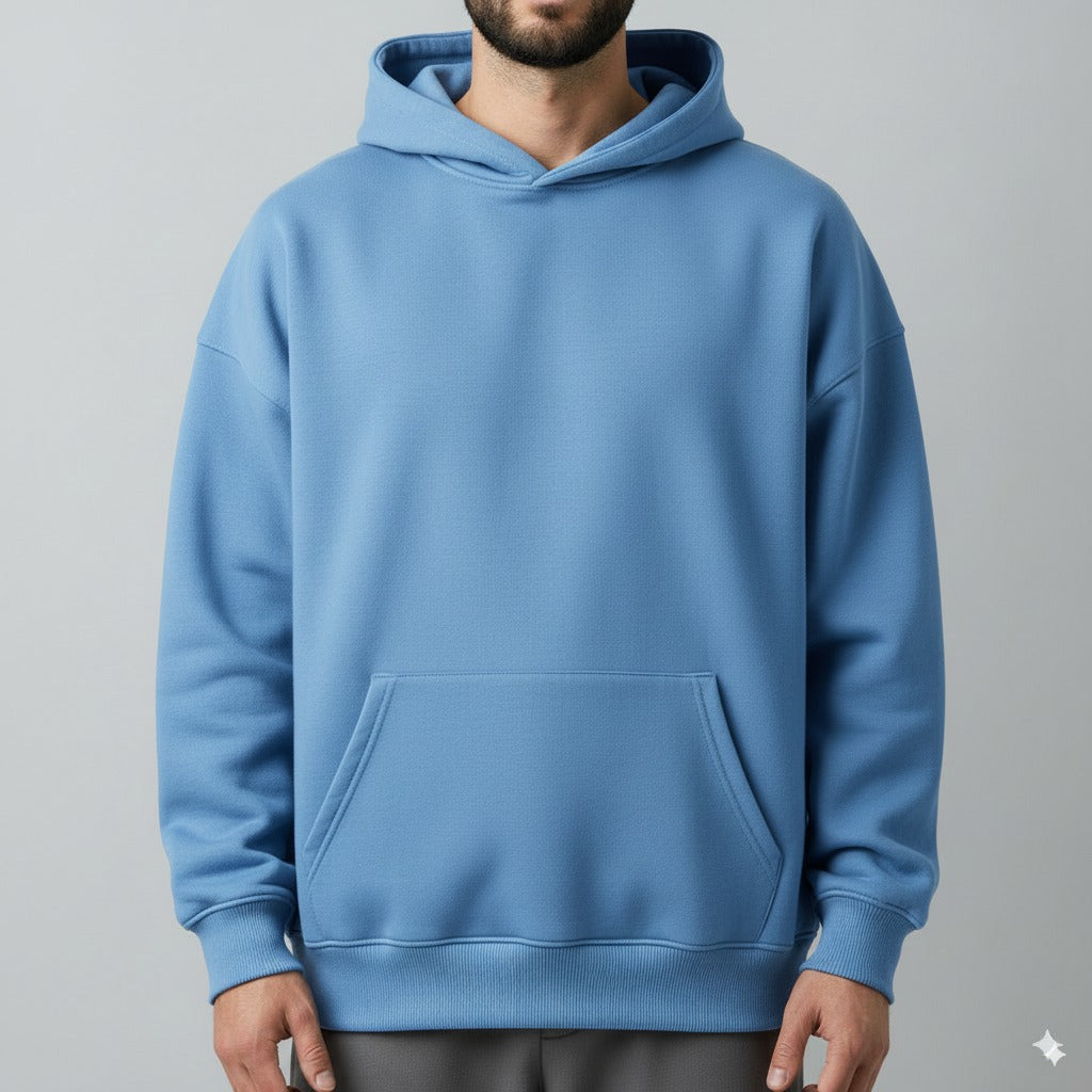 Person wearing a blue hoodie on a gray background