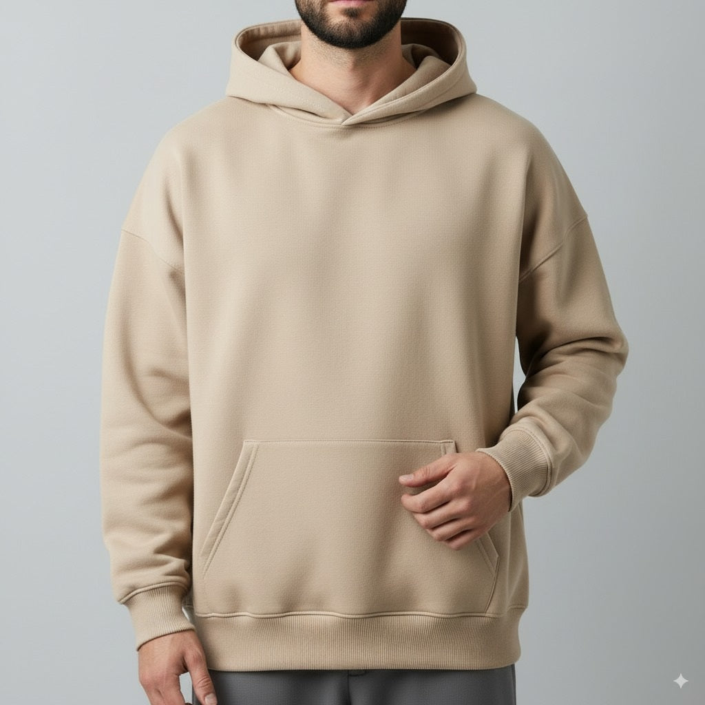 Beige hoodie worn by a person on a gray background